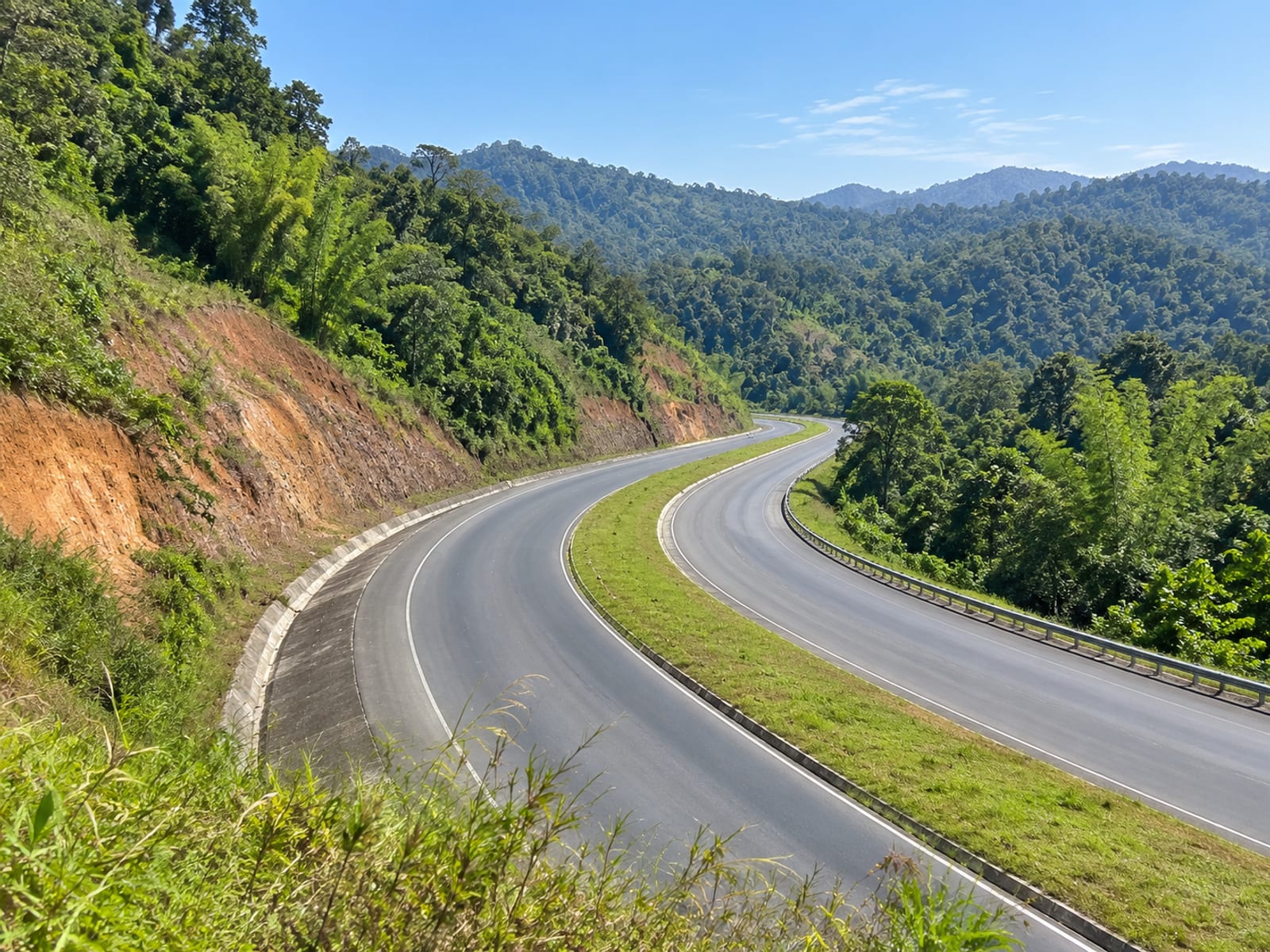 A winding highway curving through green hills in St. Ann