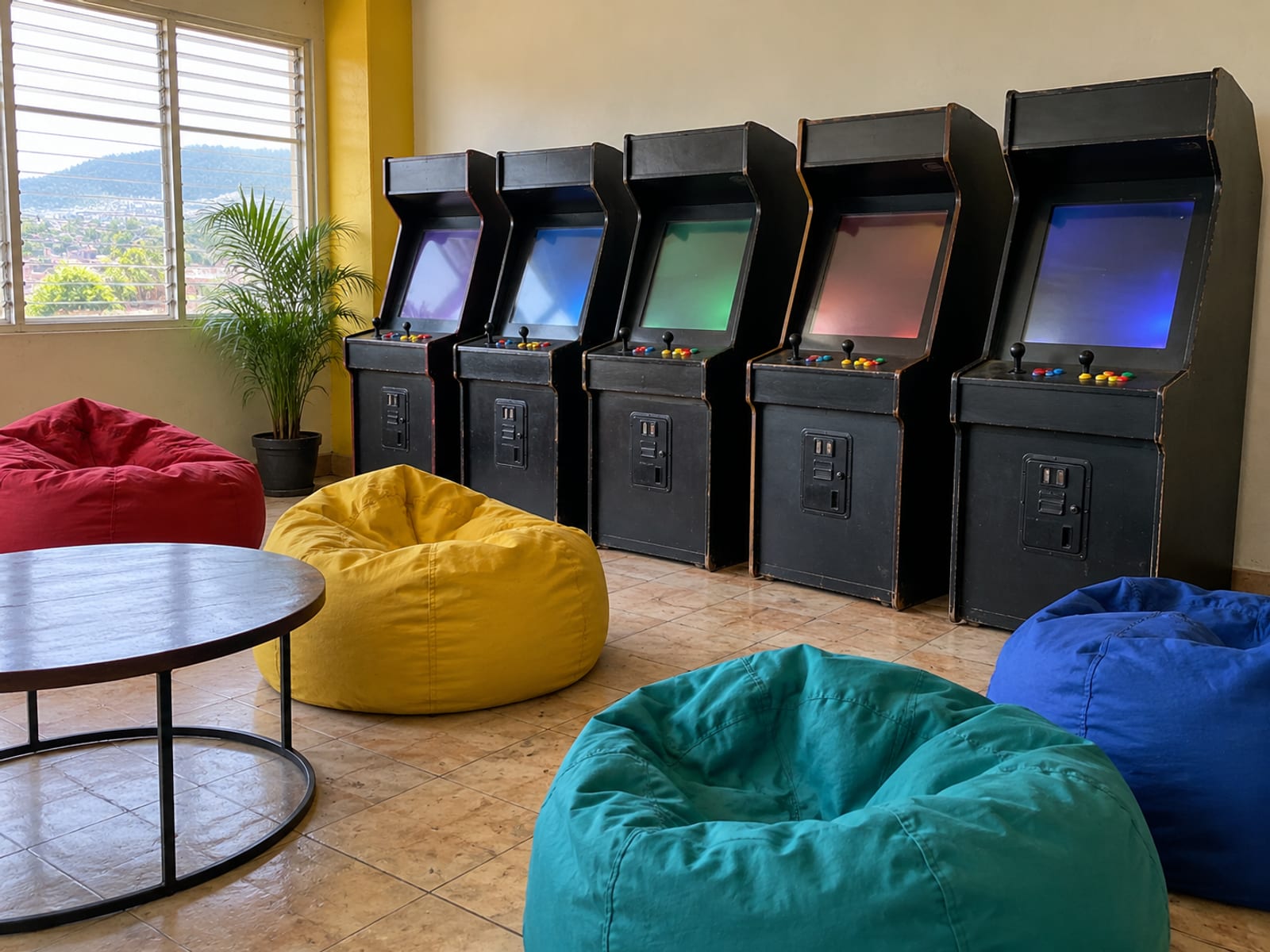 A bright game room with arcade machines and bean bags, empty of people