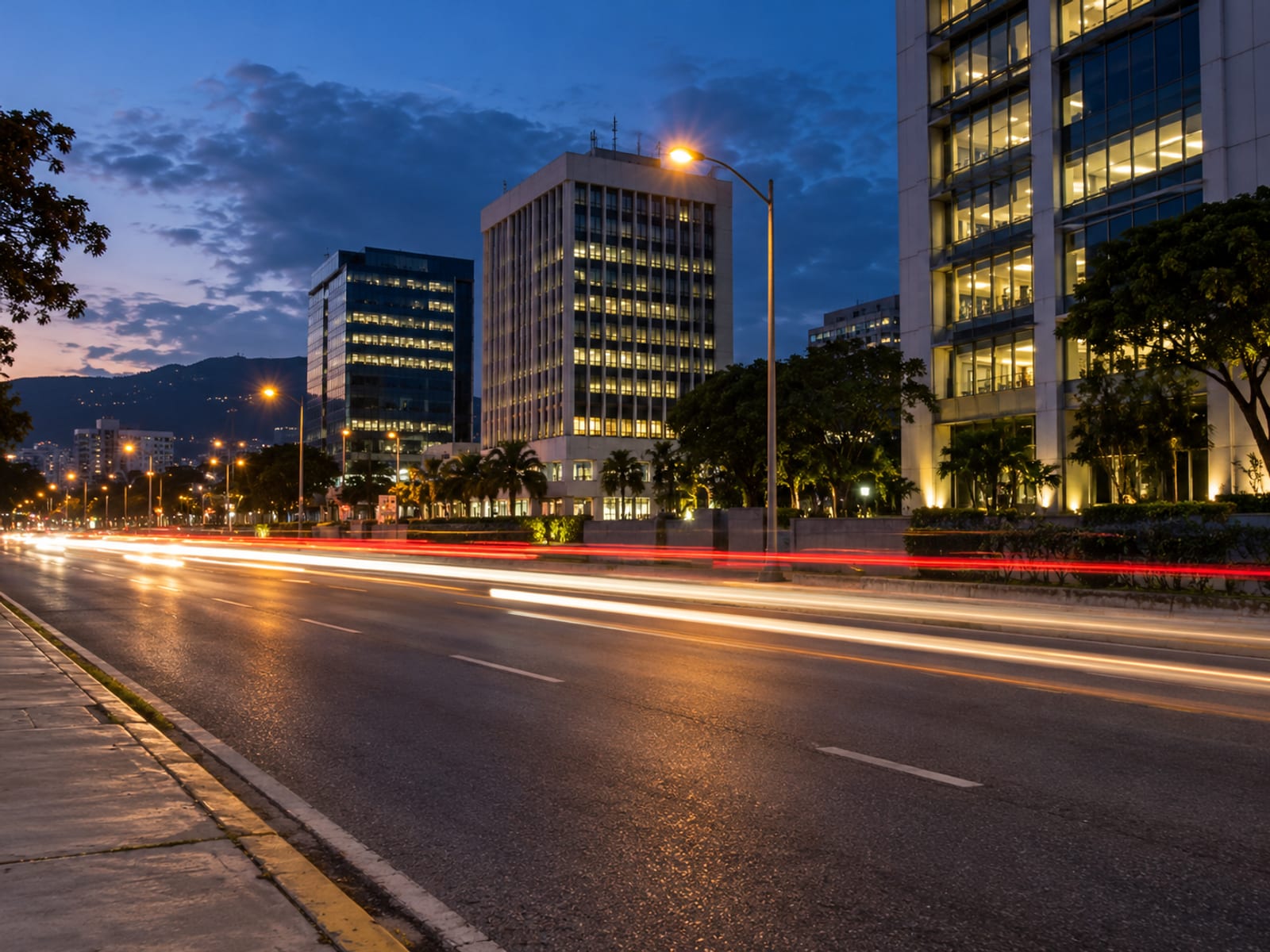 A busy city street at dusk with lit buildings and traffic