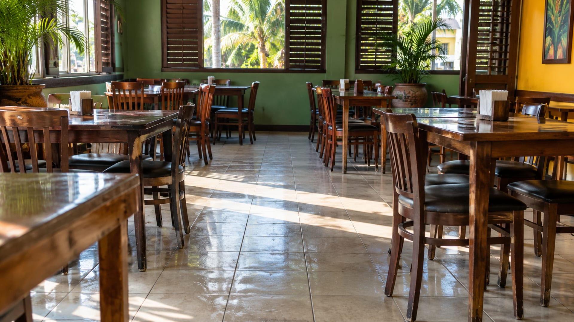 A clean restaurant dining room after lunch with sunlight on the floor